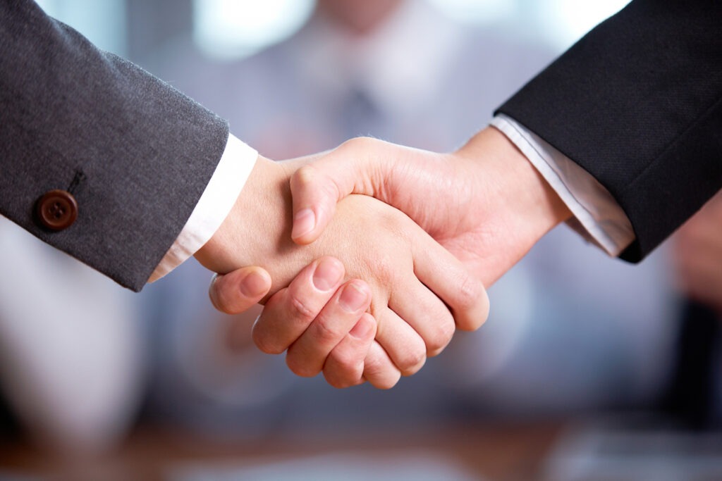 Photo of handshake of business partners after striking deal